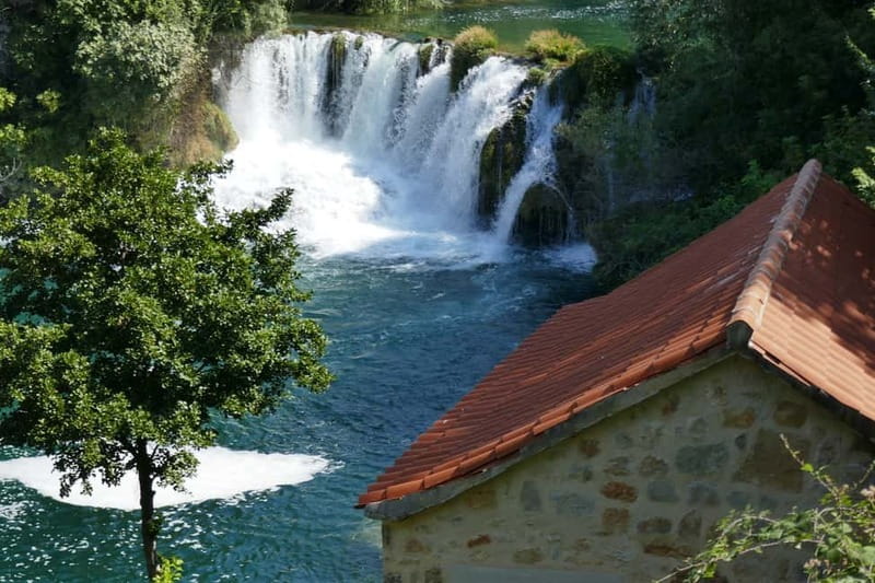 From Split: Krka Waterfalls with Riverboat Ride & swimm stop - Entering Krka by riverboat