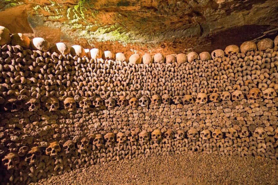 Paris: Catacombs Entry & Seine River Cruise with Audio Guide - The Catacombs Begin With a Long Stairway Down