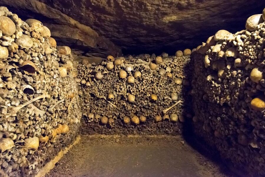 Paris: Catacombs Ticket and Seine River Cruise - Walking through the Catacombs beneath Paris