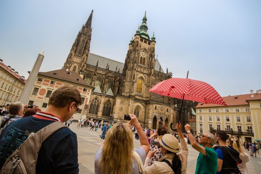 Prague: Guided Bus & Walking Tour with River Cruise & Lunch - Walking from the castle toward Charles Bridge